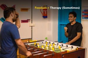 two men standing next to a table with at goSTOPS Lite Alleppey in Alleppey +25 photos