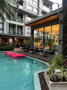 a large swimming pool in front of a building at Diamond Condo apart near Bangtao beach in Bang Tao Beach
