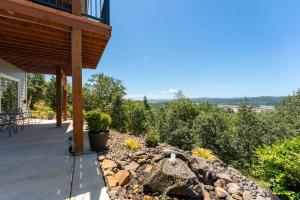 een veranda van een huis met een stenen muur bij Panoramic River Views - Nature Framed in Every Window in Kalama