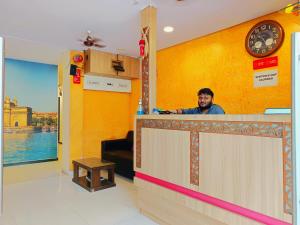 a man standing at the counter of a restaurant at Hotel P I international in Mumbai