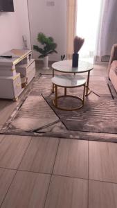 a living room with a coffee table and a rug at Modern Smart Apartment with Easy Access in Mtwapa