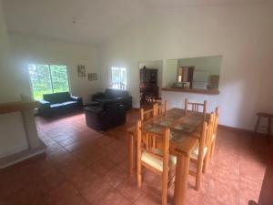 a living room with a wooden table and chairs at Casa Nueva Holanda in Las Vigas