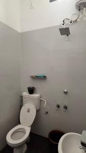 a bathroom with a toilet and a sink at Thanal in Trivandrum