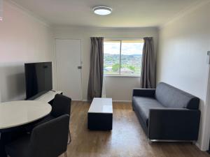 a living room with a couch and a table at Walcha Villas in Walcha
