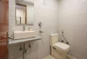 a bathroom with a toilet and a sink and a mirror at Hotel Prem Dx 2 Min Walk From New Delhi Railway Station in New Delhi