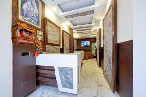 a hallway with a white counter in a room at Hotel Prem Dx 2 Min Walk From New Delhi Railway Station in New Delhi