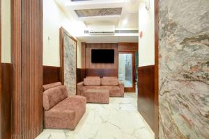 a living room with two chairs and a flat screen tv at Hotel Prem Dx 2 Min Walk From New Delhi Railway Station in New Delhi +17 photos