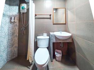 a bathroom with a toilet and a sink at Thepmongkol House in Bangkok