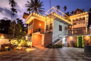 a house with lights on the side of it at VGK Residency in Wayanad