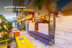 a store with a bench on the side of it at goSTOPS Lite Varanasi in Varanasi