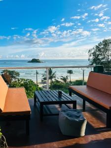 a patio with a view of the ocean at Arana Weligama in Weligama