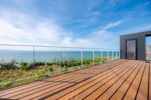 a wooden deck with a view of the ocean at the SHIHACHI  +29 photos