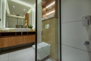 a bathroom with a toilet and a sink at Royale Suites - 3 BHK Serviced Apartment in Kadayirippu