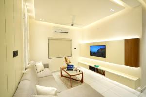 a living room with a couch and a table at Royale Suites - 3 BHK Serviced Apartment in Kadayirippu