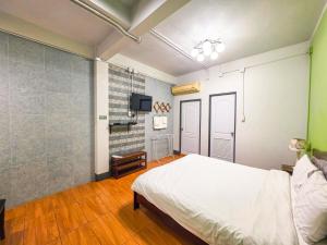 a bedroom with a white bed and a tv at Thepmongkol House in Bangkok +22 photos