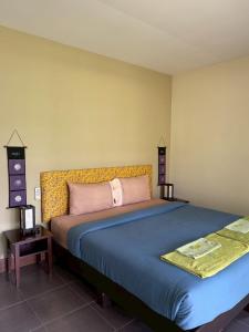 a bedroom with a large bed in a room at Sweet Mango Khaolak in Khao Lak