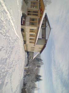 a building on the side of a snow covered mountain at Penzión Šindléry 533 in Partizánska ľupča +6 photos