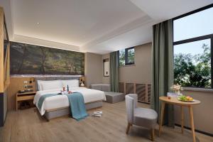 Ένα ή περισσότερα κρεβάτια σε δωμάτιο στο 秋果酒店西安钟楼北大街地铁站店