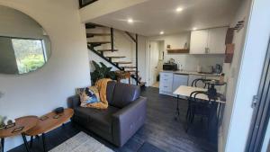 a living room with a couch and a kitchen at Magpie and Stump Hotel 'Nest Accommodation' and 1km offsite 'Loft 7' Studio in Mintaro