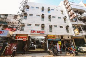 a large white building on the corner of a street at Hotel Lav Kush Deluxe 2 Min Walk From New Delhi Railway Station in New Delhi