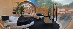 a bedroom with a bed and a play house at Bubble Glamping Sicily in Trecastagni +70 photos