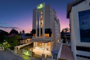 a hotel with a sign on the side of a building at Lemon Tree Premier, Thiruvananthapuram in Trivandrum