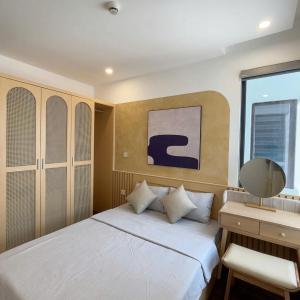 Ένα ή περισσότερα κρεβάτια σε δωμάτιο στο Hoang Huy Commerce Tower Apartment & Homestay