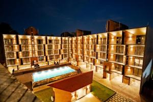 a building with a library with a swimming pool at SinQ Village in Bambolim