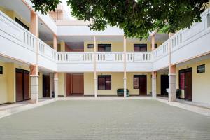 an empty courtyard of a building with a tree at Hotel O Griya Cewang Syariah in Bekasi