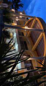a building with lights on the side of it at KERESI BLOCK At PENIEL BEACH HOTEL in Entebbe