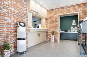 een kamer met een bakstenen muur en een klok in een winkel bij Jeonju Summit Stay in Jeonju