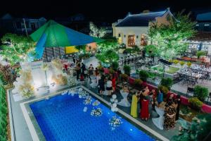 a group of people standing around a pool at a party at Kangaroo homestay in Cat Ba