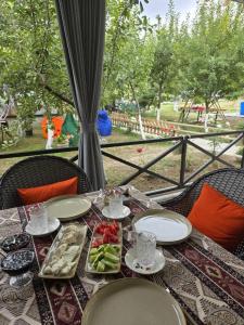 a table with plates and bowls of food on it at Zeyvə Farm House 