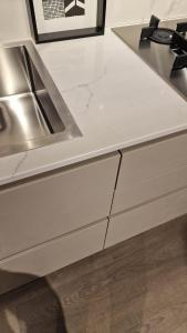 a kitchen with a sink and a counter top at ClaMar Apart Hotel in Porto Ercole