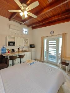a bedroom with a bed and a ceiling fan at LaBelleVue Antigua Oceanview Suites and OnSite Car Rentals in Crosbies +74 photos