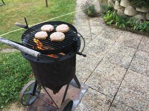 a grill with three donuts cooking on it at Apartments in Harrachov - Riesengebirge 2300 in Harrachov
