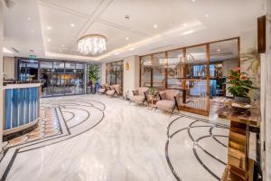 a lobby of a hotel with chairs and a chandelier at Grand Hilarium Hotel in Istanbul +66 photos