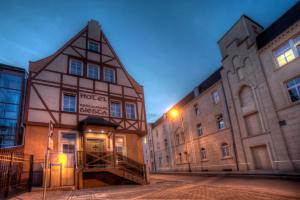 an old building in the middle of two buildings at Hotel Siesta in Świebodzin