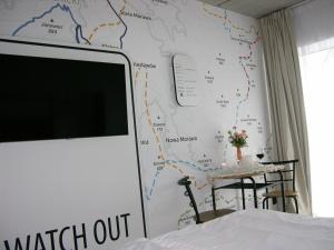 a tv on a wall with a map on it at Czarna Góra- Biała Perła z mini aneksem - 403 in Sienna
