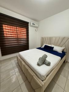 a bedroom with a bed with two slippers on it at LibiMar in Manta