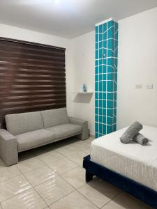 a living room with a bed and a couch at LibiMar in Manta