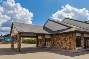 a building with a metal roof on top of it at Days Inn by Wyndham Branson Ozarks in Branson