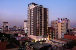 a tall building in a city at night at Poulo Wai Hotel, Trademark Collection by Wyndham in Phnom Penh