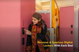 a woman standing in a room looking at her phone at goSTOPS Coorg in Madikeri +36 photos