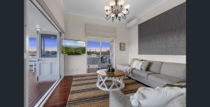 a living room with a couch and a table at Parkside Family Haven - 5bdrm in Brisbane