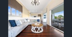 a living room with a couch and a table at Parkside Family Haven - 5bdrm in Brisbane