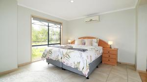 a bedroom with a bed and a large window at Sweet Home at Carrum Downs in Carrum Downs +17 photos