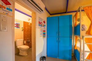 a bathroom with a toilet and a blue cabinet at goSTOPS Coorg in Madikeri +47 photos