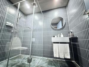 a bathroom with a shower and a sink and a mirror at Gyeongju Mauna Ocean Resort in Gyeongju +122 photos