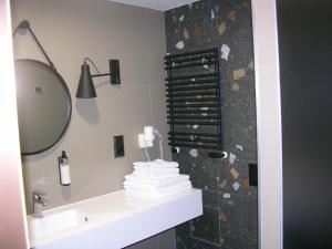 a bathroom with a sink and a shower with a mirror at Czarna Góra- Biała Perła z mini aneksem - 403 in Sienna